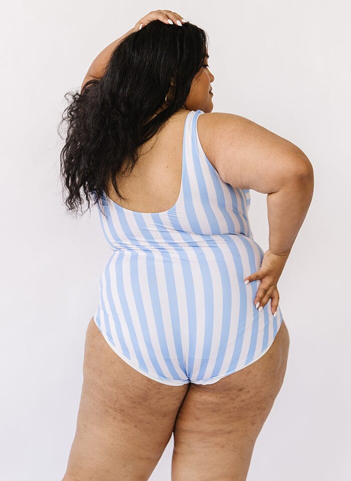 Photo of a woman wearing a peri stripe knotted one-piece swim suit back angle