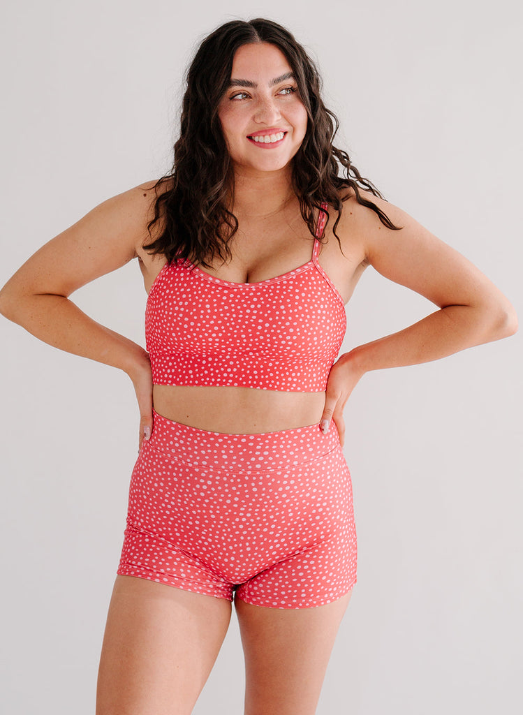 Photo of woman wearing pink dot bralette swim top with pink dot swim shorts
