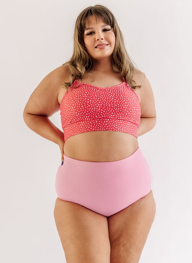 Photo of woman wearing pink dot bralette swim top with pink swim bottoms