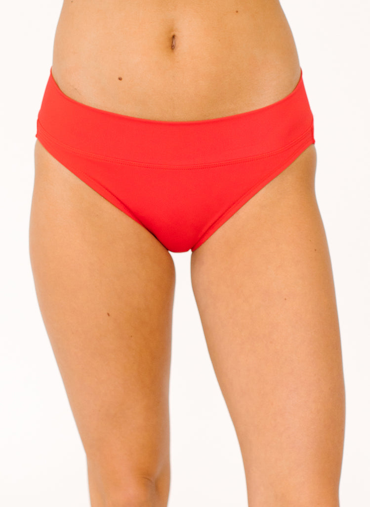Close up photo of woman wearing red classic low rise swim bottoms