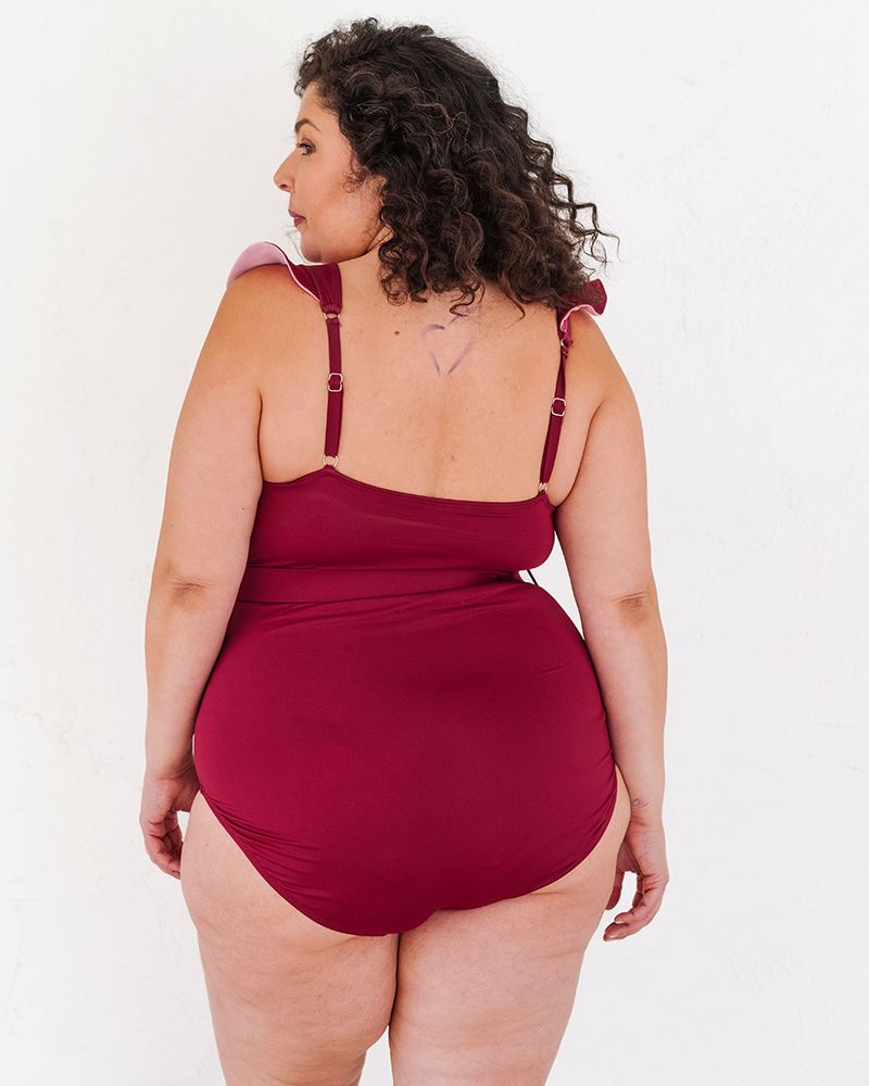 Photo of a woman wearing a Burgundy Ruffle one-piece swim suit back angle