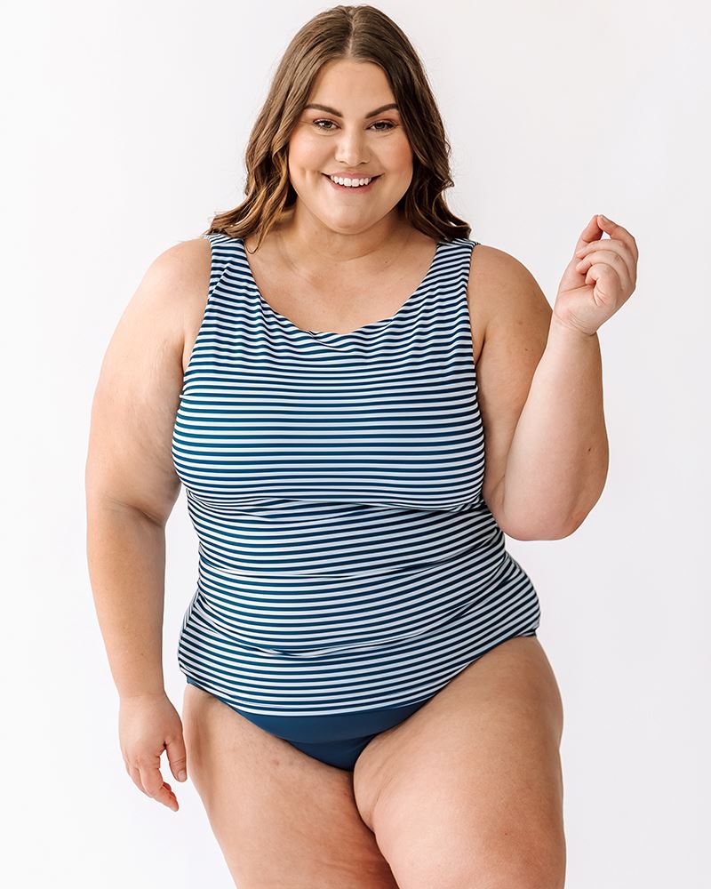 Photo of a woman wearing an Indigo stripe boat-neck swim top and an Indigo swim bottom