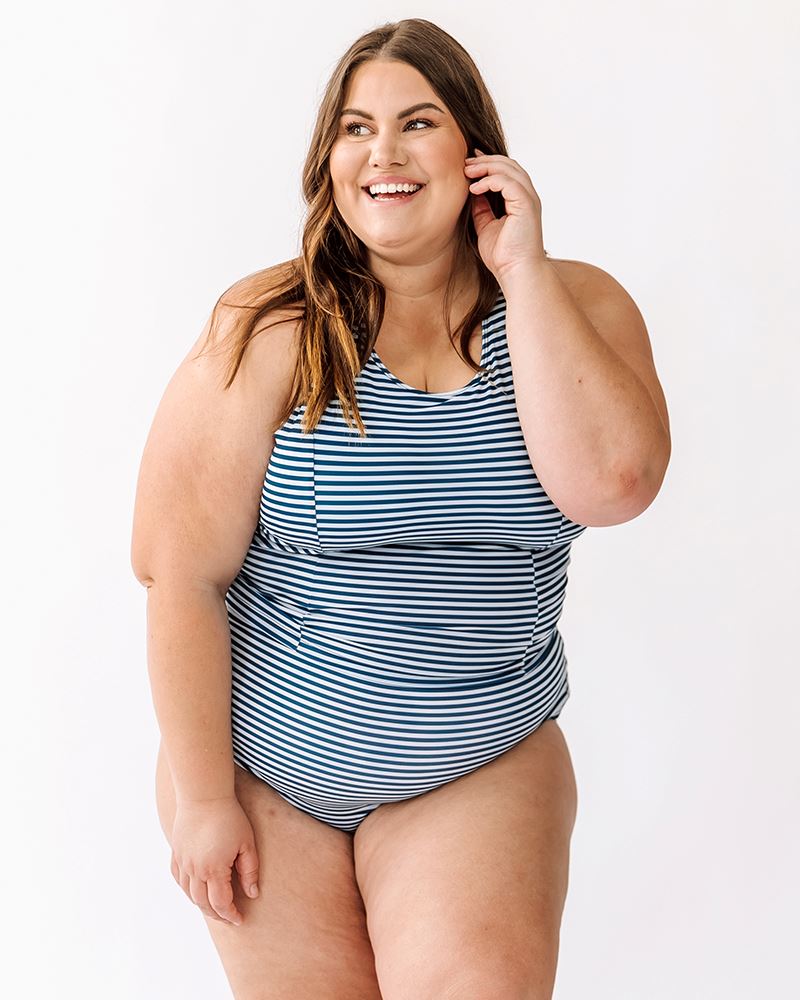 Photo of a woman wearing an Indigo stripe cross-back swim crop top and an Indigo stripe swim short bottom