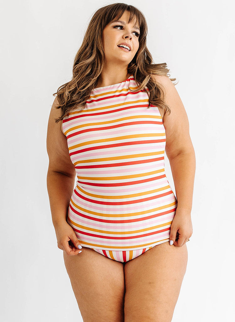 Photo of woman wearing multi color stripe boat neck swim tankini with multi color stripe swim bottoms