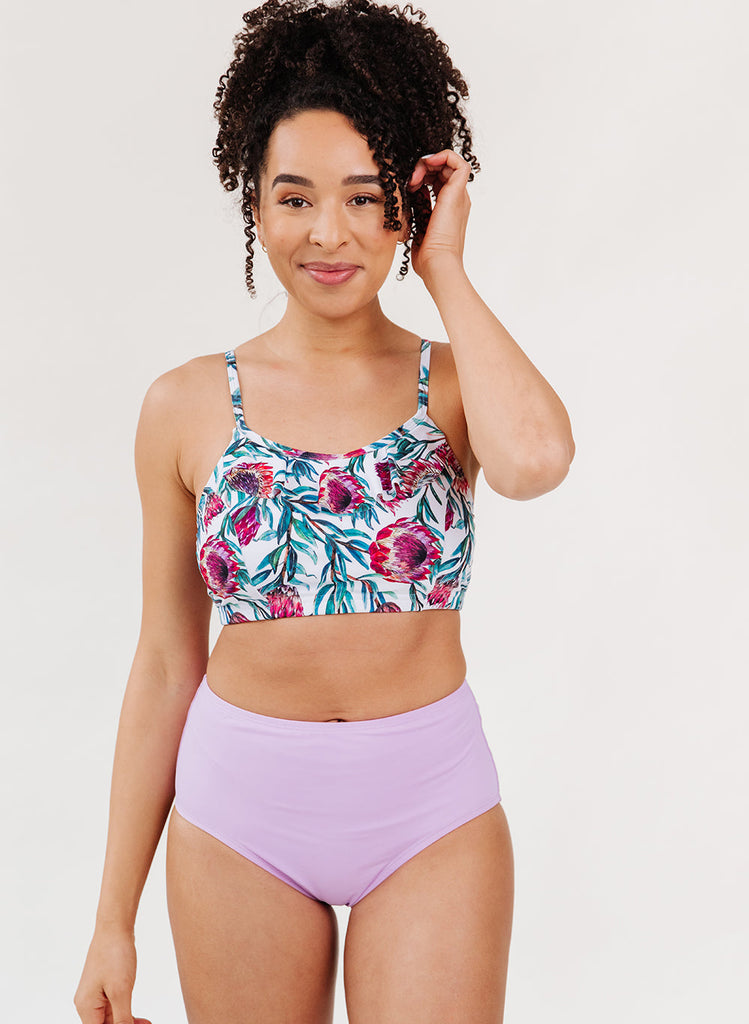 Photo of a woman wearing a desert floral swim bralette and a lavender swim bottom