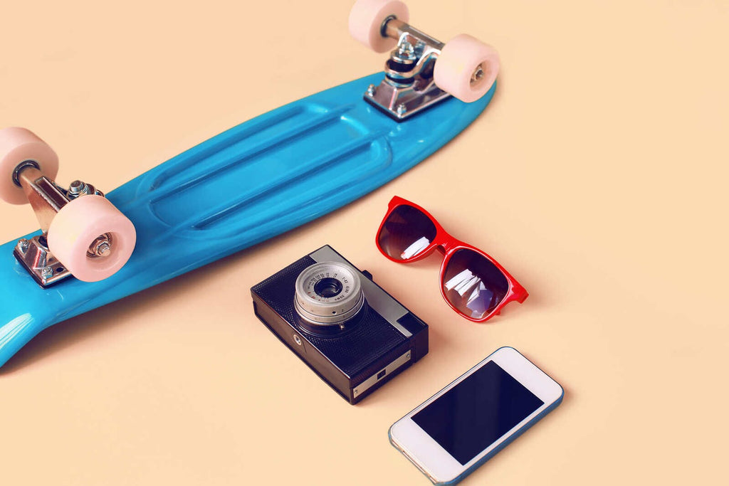  Blue skateboard, red sunglasses, vintage camera, phone