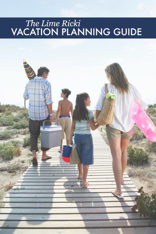 a family walking on a wooden panel with beach equipment