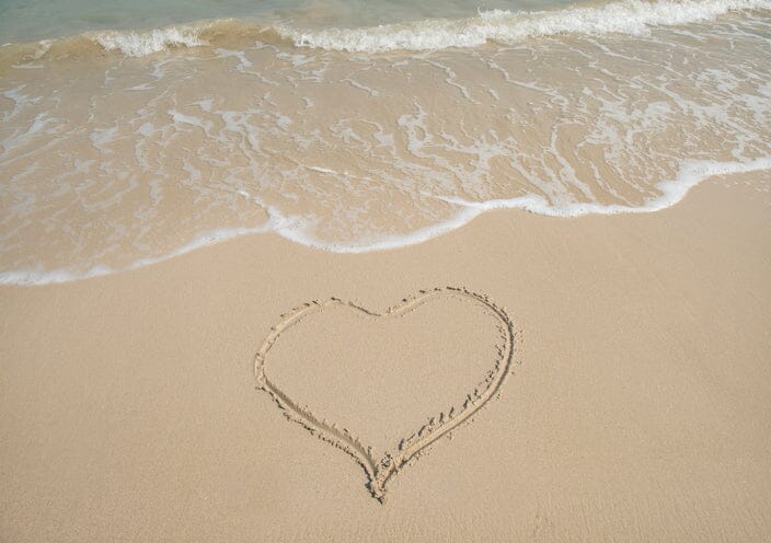 Heart drawn on beach sand