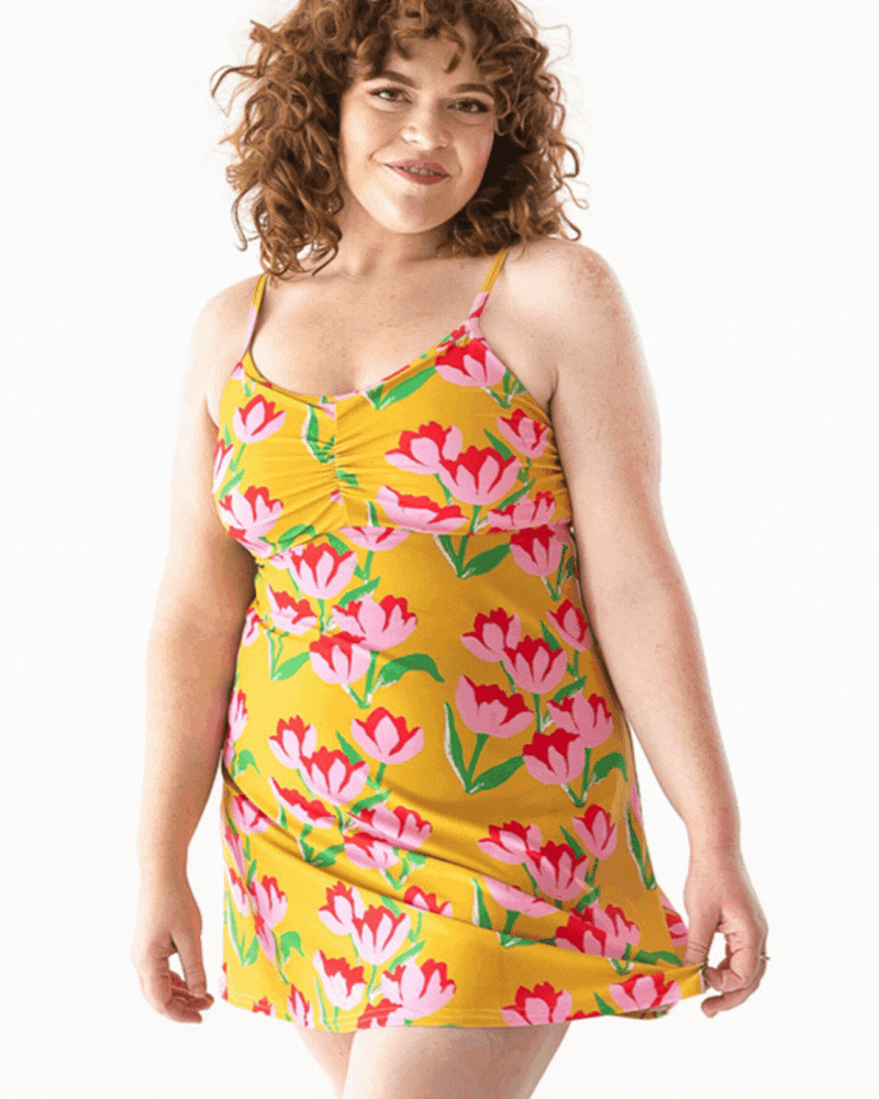 GIF of a woman wearing a Claus swim dress one-piece