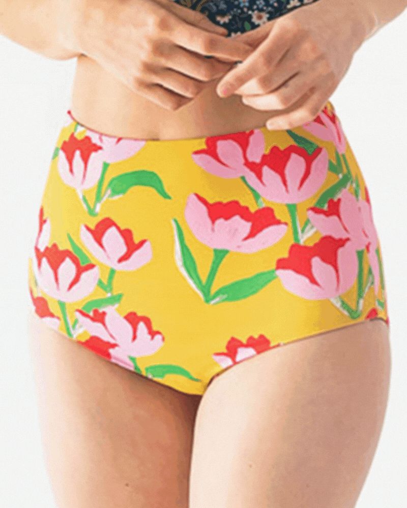 GIF of a woman wearing a Claus/Tage reversible swim bottom