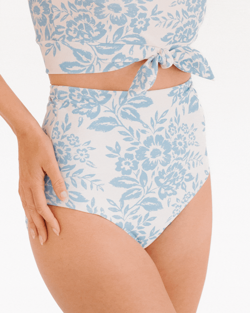 GIF of a woman wearing a Peri Lace/ Peri reversible swim bottom and a Peri lace swim crop top