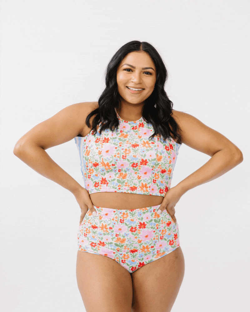 GIF of a woman wearing a multi color floral swim crop top and floral swim bottoms