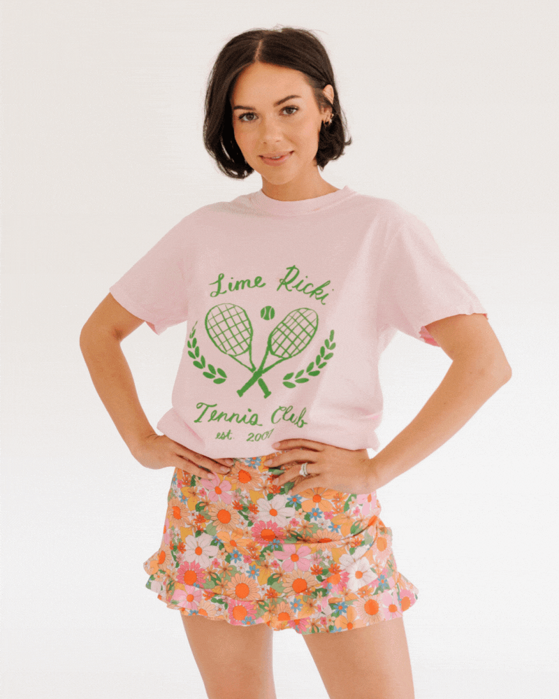 GIF of woman wearing lime ricki tennis club graphic tee with multi colored floral swim skirt