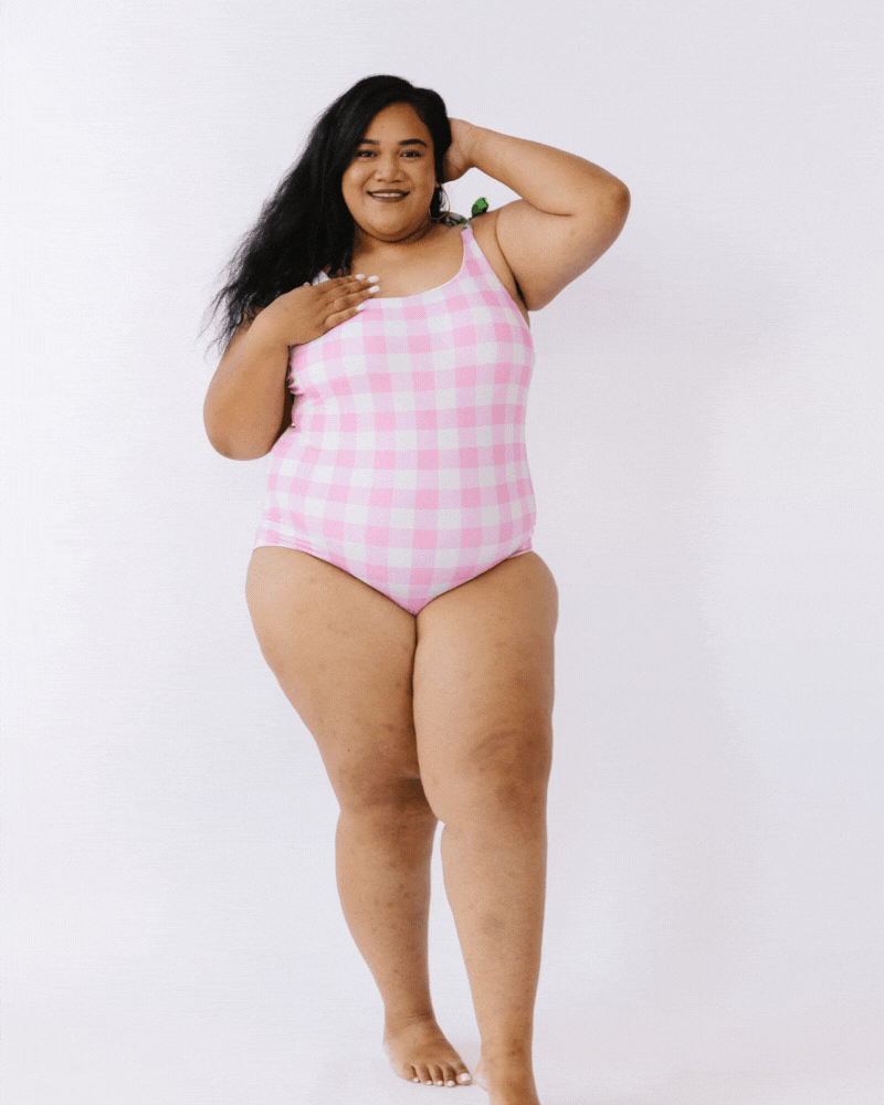 GIF of woman wearing pink gingham swim one piece