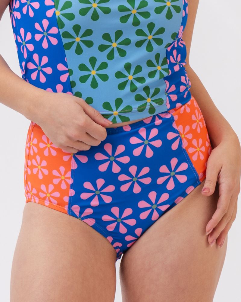 Close-up photo of a woman wearing a multi-colored floral high-waist swim bottom