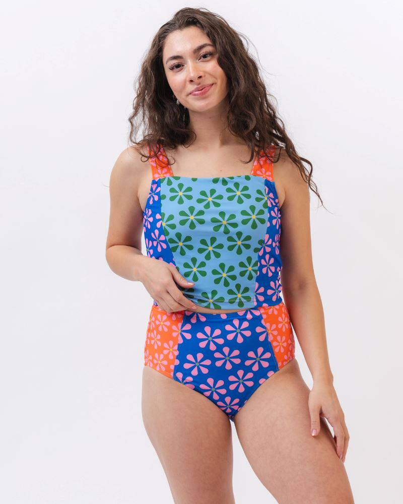 Photo of a woman wearing a multi-colored floral square neck swim crop top and a multi-colored floral swim bottom
