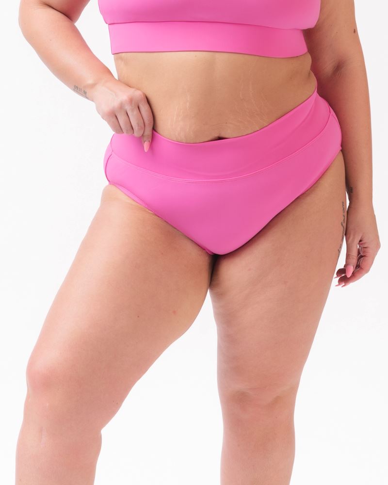 Photo of a woman wearing a dark pink classic swim bottom