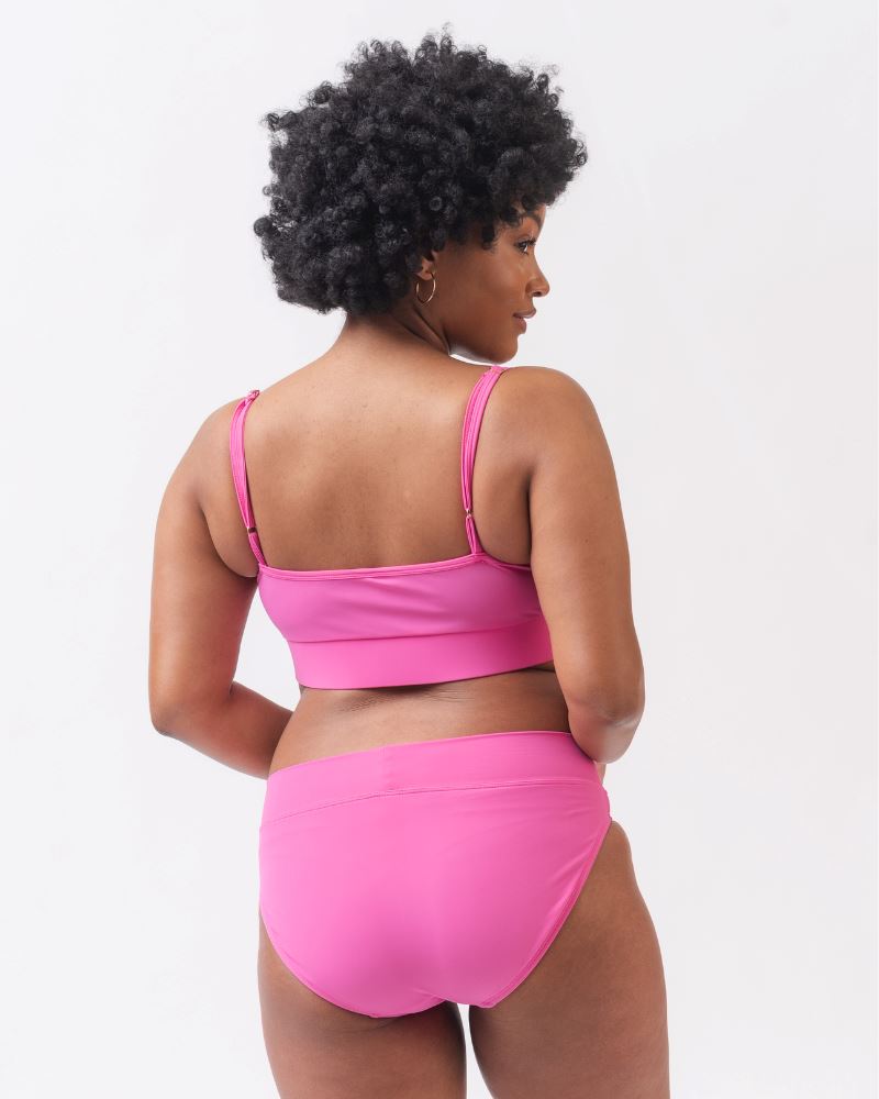 Photo of a woman wearing a dark pink swim bralette and a dark pink swim bottom-back angle 