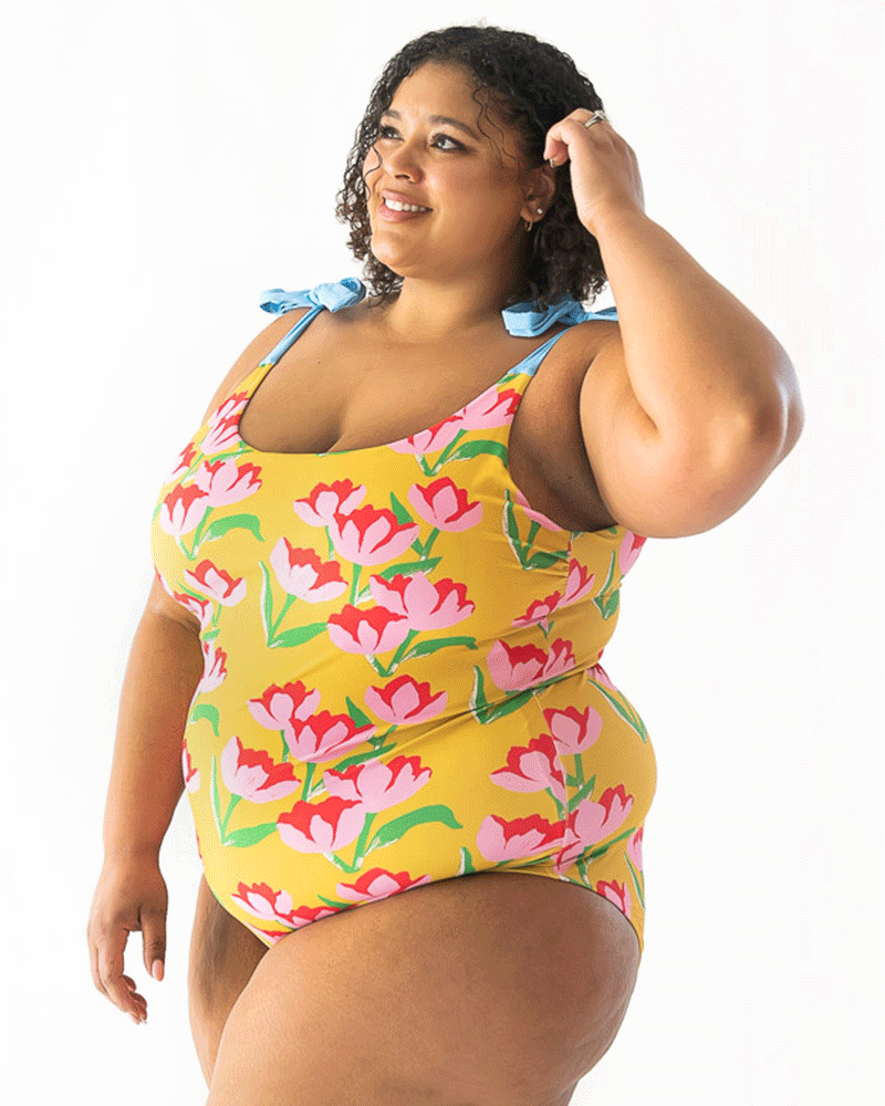 GIF of a woman wearing a Claus shoulder-tie one-piece swim suit