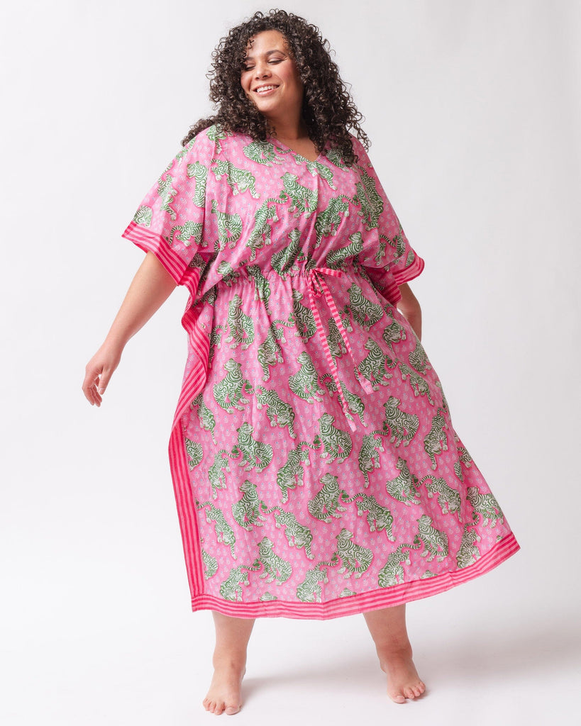 Photo of a woman wearing a bold pink and green tiger print long cover up