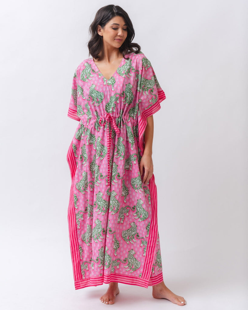 Photo of a woman wearing a bold pink and green tiger print long cover up