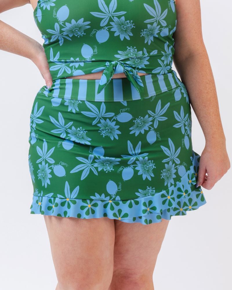 Close-up photo of a woman wearing a green and blue floral swim skirt