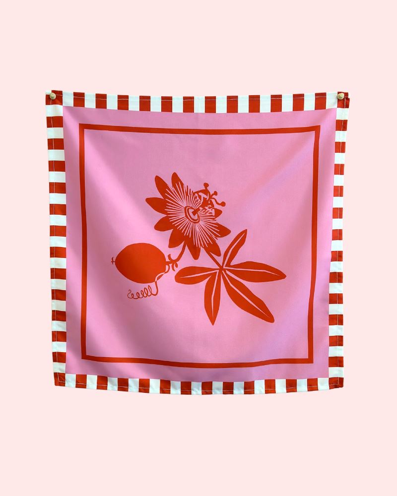 Photo of a pink and red floral bandanna with a red and white striped boarder