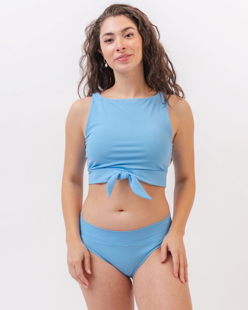 Photo of a woman wearing a light periwinkle blue classic swim bottom with a light periwinkle blue swim crop top