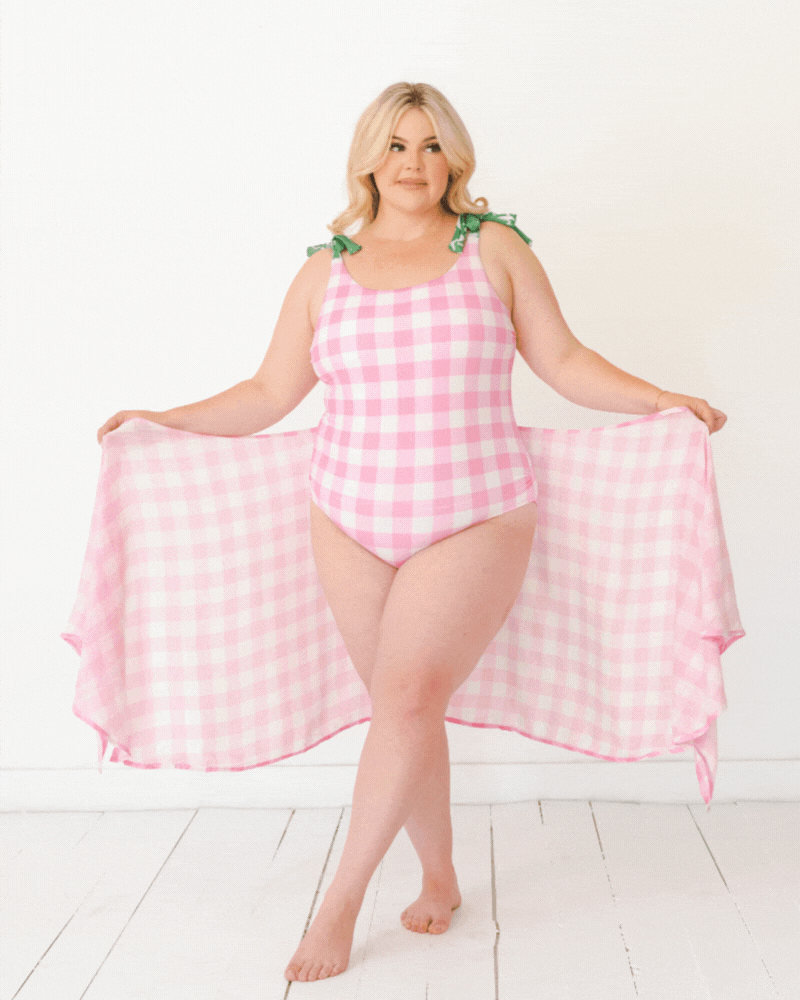 GIF of a woman wearing a pink and white checkered Sarong and a pink and white checkered swim suit