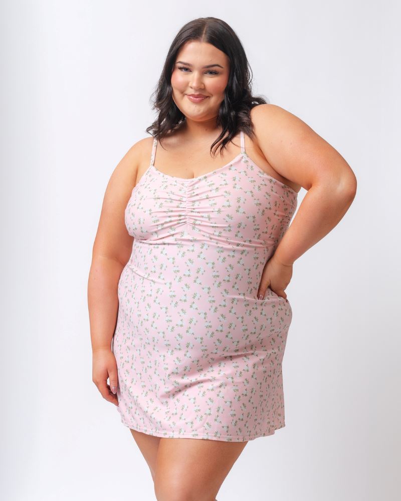 Photo of a woman wearing a pink floral swim dress
