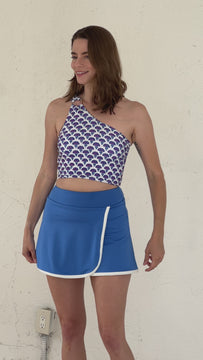 Video of a woman wearing a Capri swim skirt bottom and a Block floral swim crop top