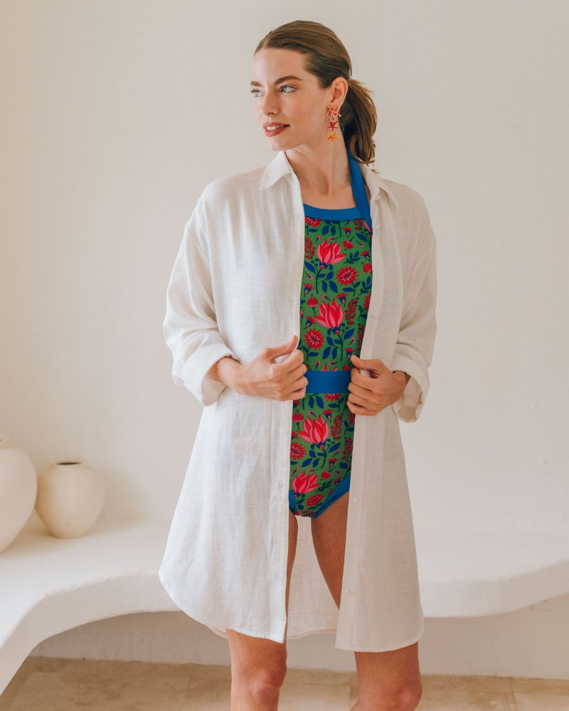 Photo of a woman wearing an Ivory Shirt Cover-up and a multi color floral swim suit