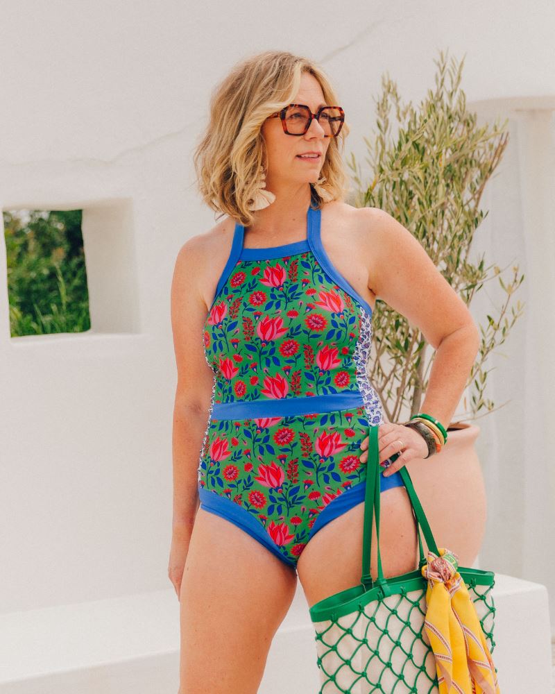 Photo of a woman wearing a Fresco Floral Halter one-piece swim suit