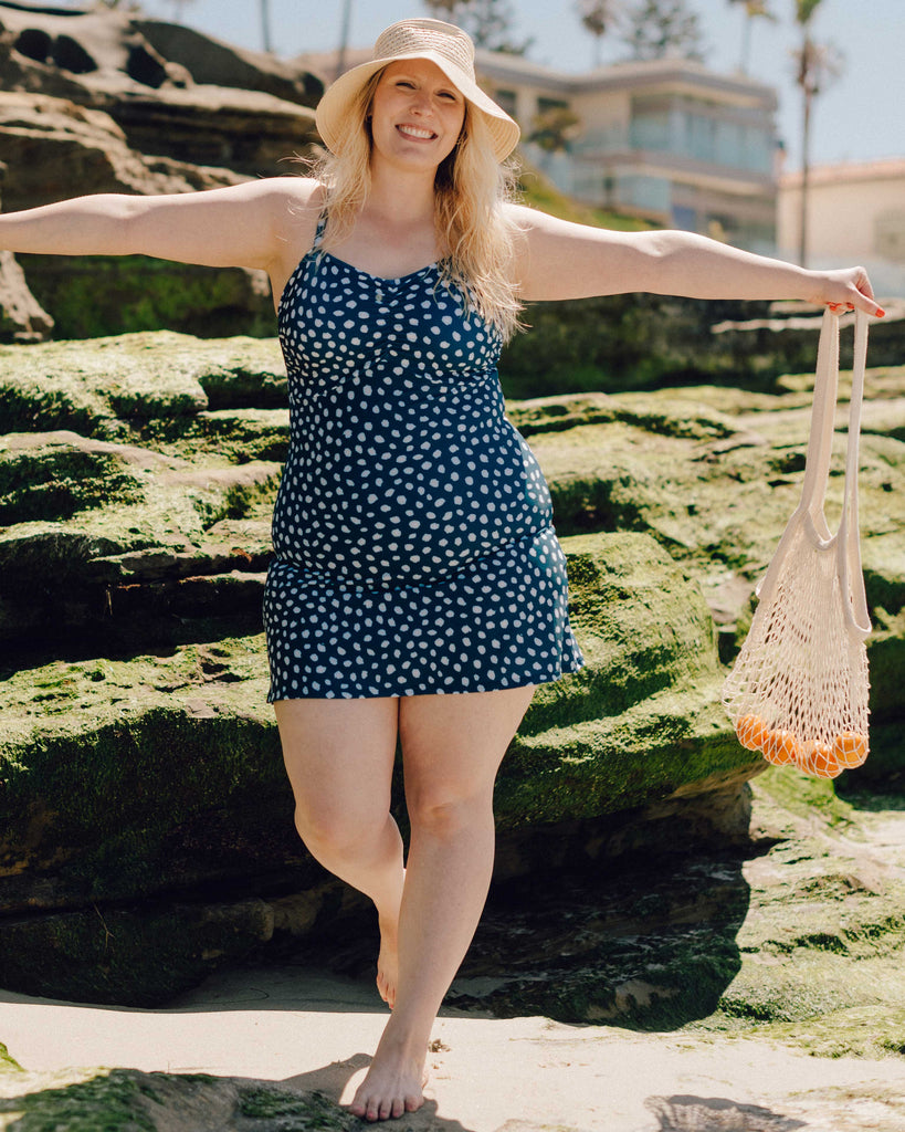 Photo of a woman wearing an Indigo dot swim dress one-piece