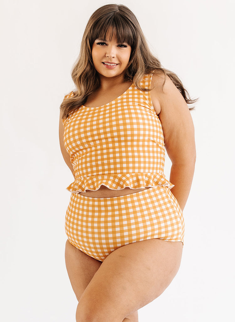 Photo of woman wearing yellow and white gingham swim top with yellow and white gingham swim bottoms
