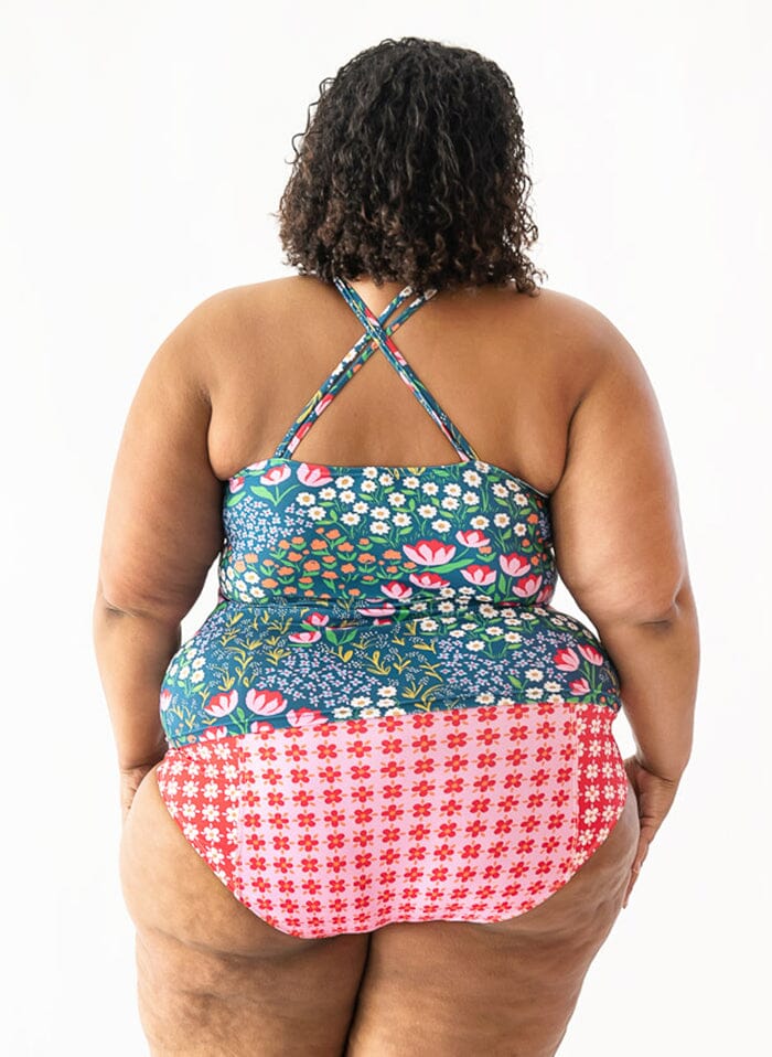 Photo of a woman wearing a Blixen double-cinch swim top and a pink floral swim bottom back angle