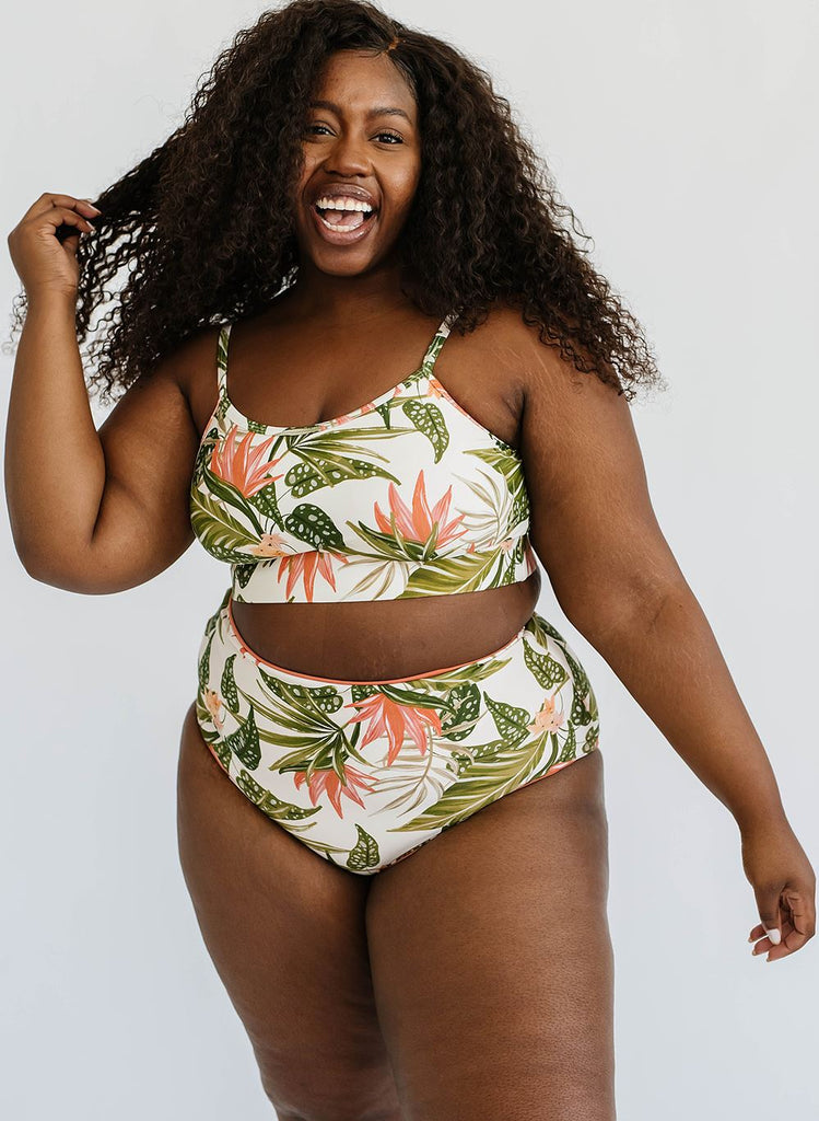 Photo of a woman wearing a green floral cropped swim top with green floral high waist swim bottoms