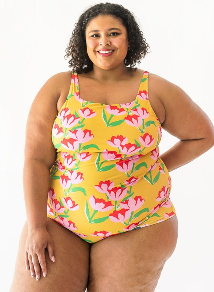 of a woman wearing a Claus square-neck swim top and a Claus swim bottom