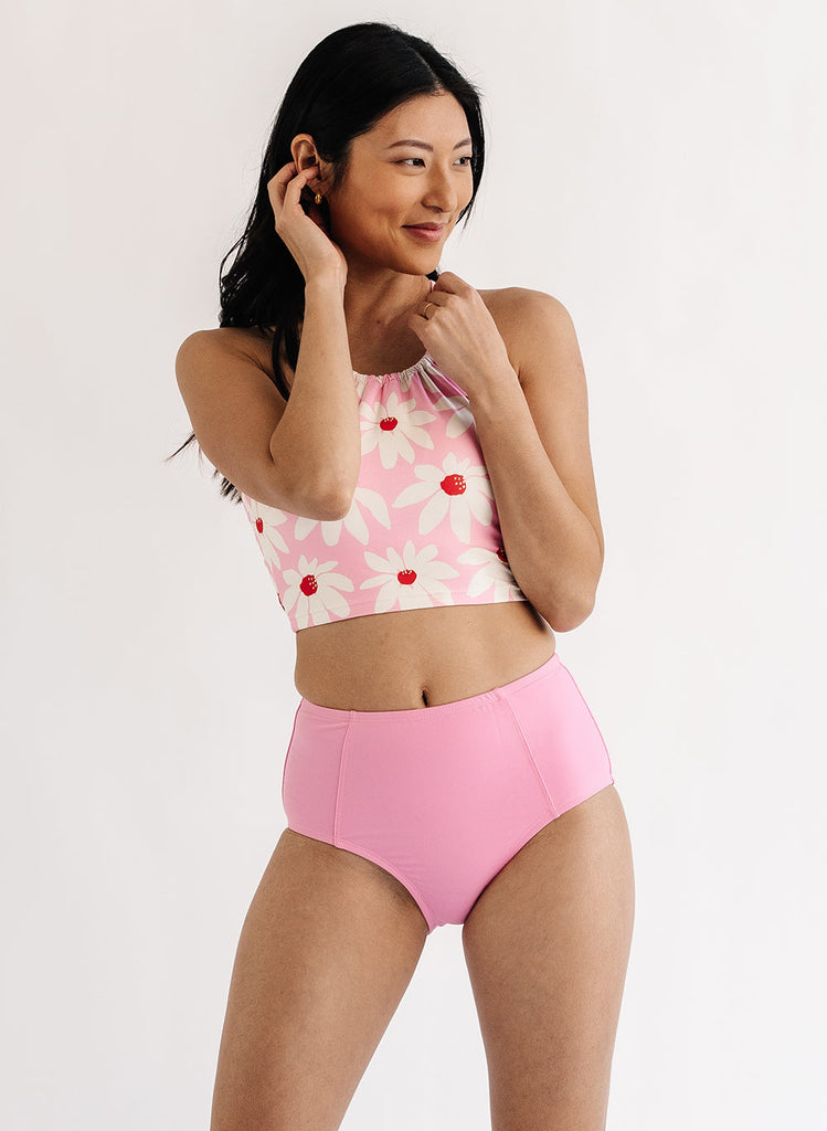 Photo of woman wearing pink floral lace back swim top with pink swim bottoms