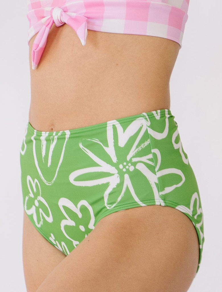 Photo of woman wearing green and white floral high waist swim bottoms