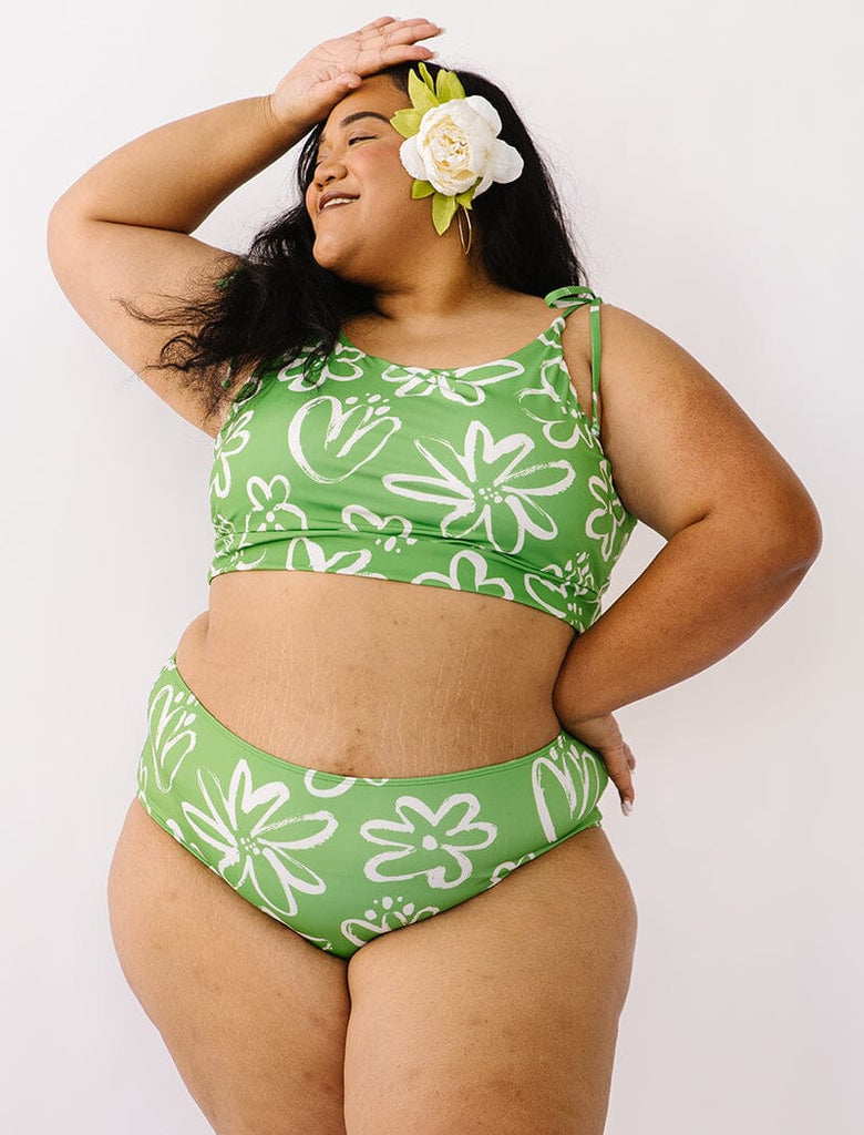 Photo of woman wearing green and white floral cropped swim top with green and white floral swim bottoms
