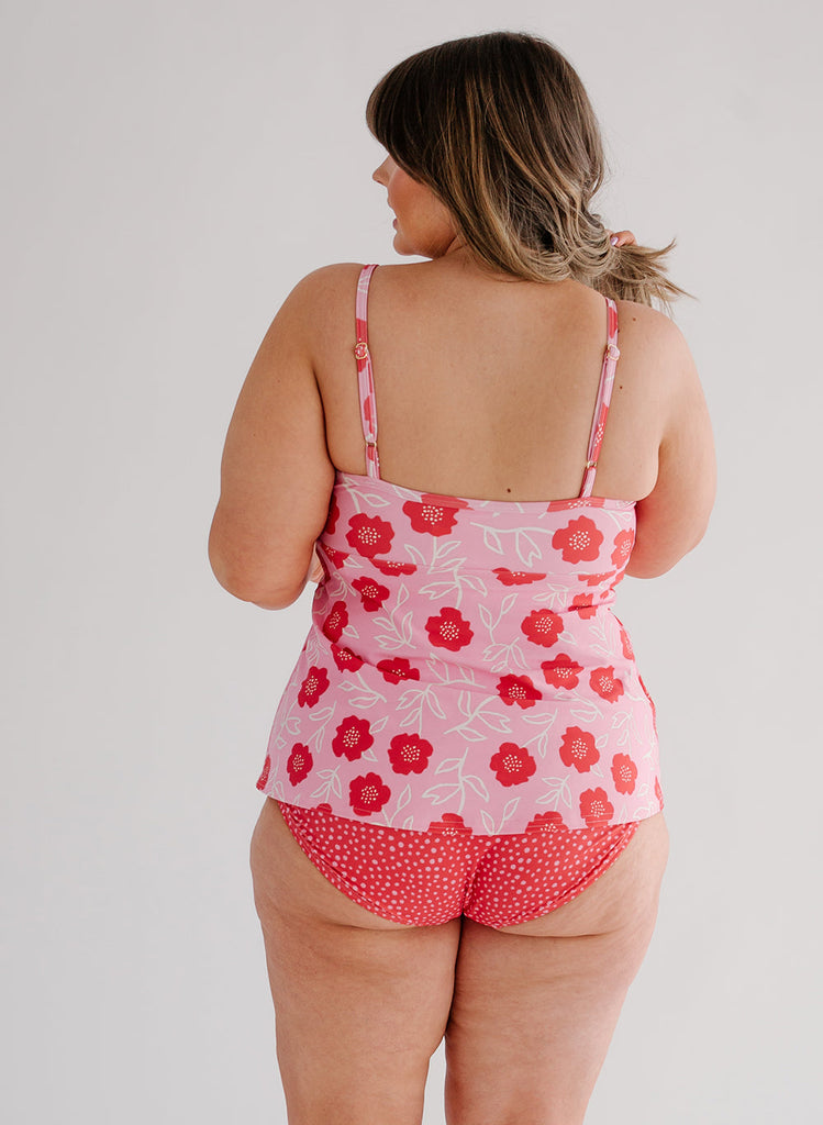 Photo of a woman wearing a Ditsy Floral swim top and a red and white dotted swim bottom back angle
