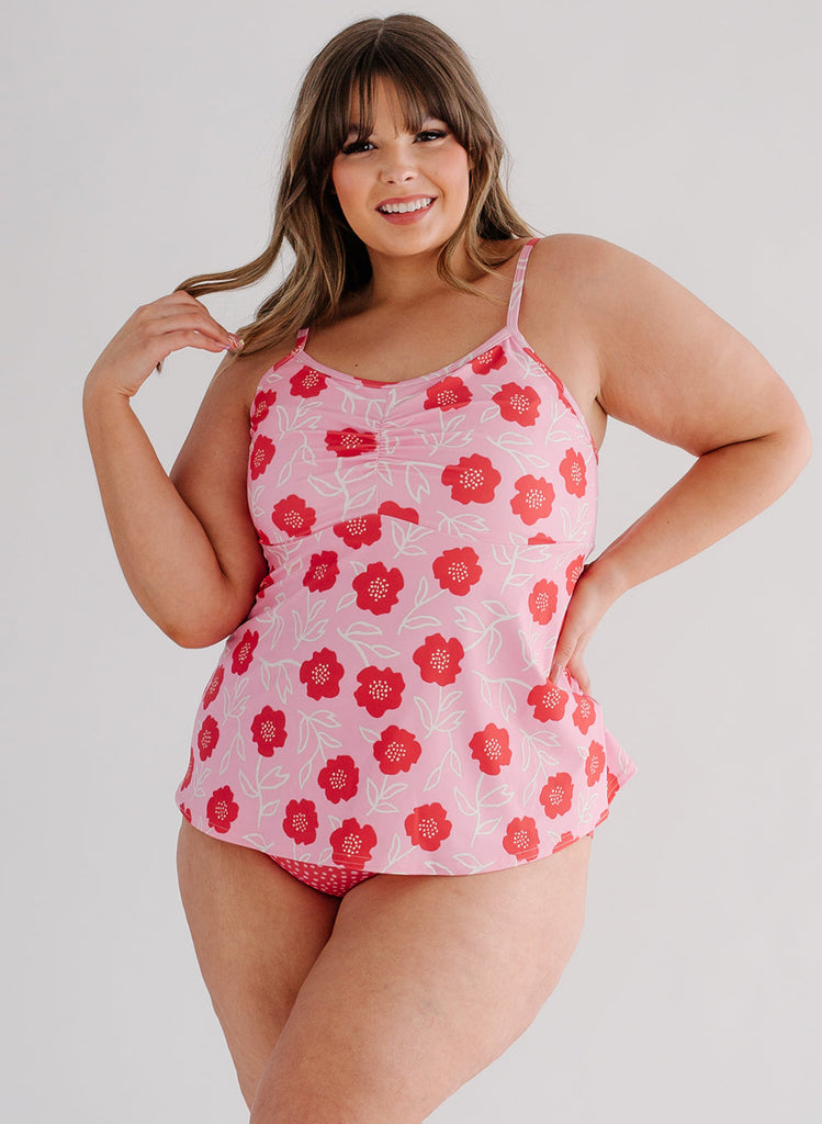 Photo of a woman wearing a Ditsy Floral swim top and a red and white dotted swim bottom