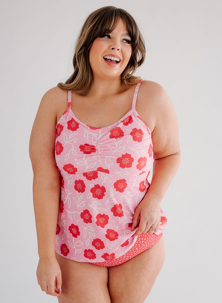 Photo of a woman wearing a Ditsy Floral swim top and a red and white dotted swim bottom