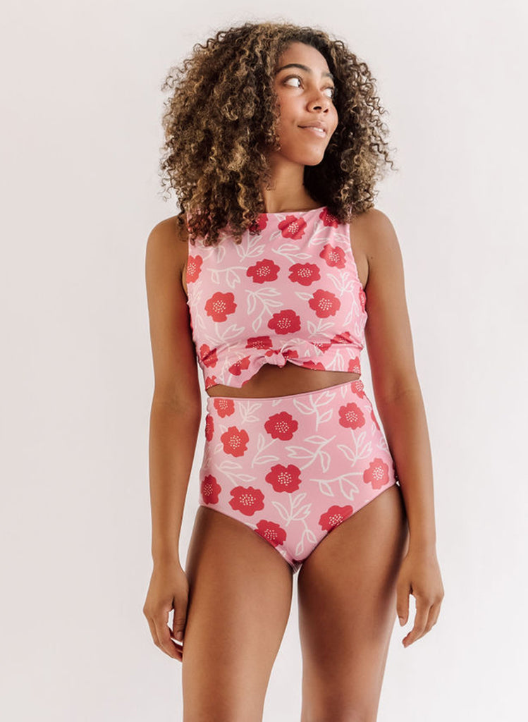 Photo of a woman wearing a Ditsy floral knotted swim crop top and a ditsy floral swim bottom