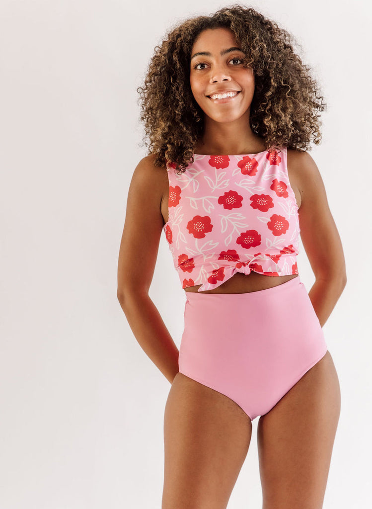 Photo of a woman wearing a Ditsy floral knotted swim crop top and a pink swim bottom
