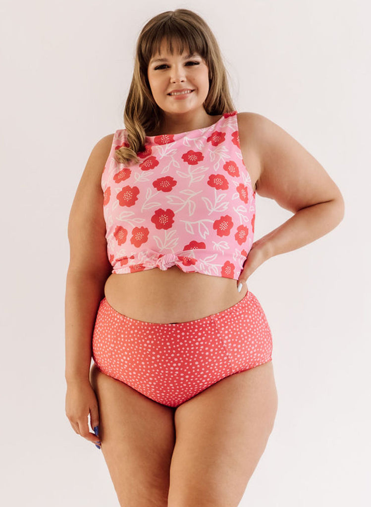 Photo of a woman wearing a Ditsy floral knotted swim crop top and a red and white dotted swim bottom