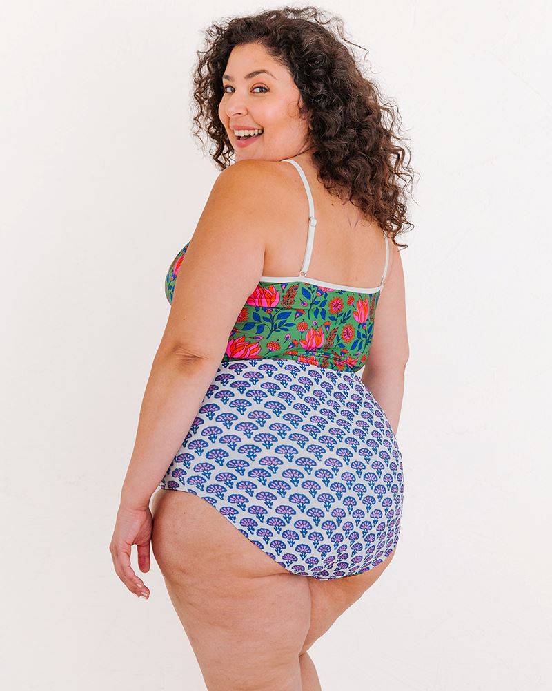 Photo of a woman wearing a Block Floral/ Fresco Floral reversible swim bottom Block floral side and a Fresco floral swim crop top back angle