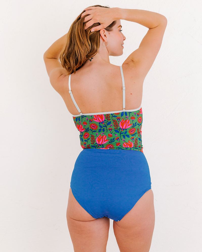Photo of a woman wearing a Fresco Floral swim crop top and a Capri swim bottom back angle