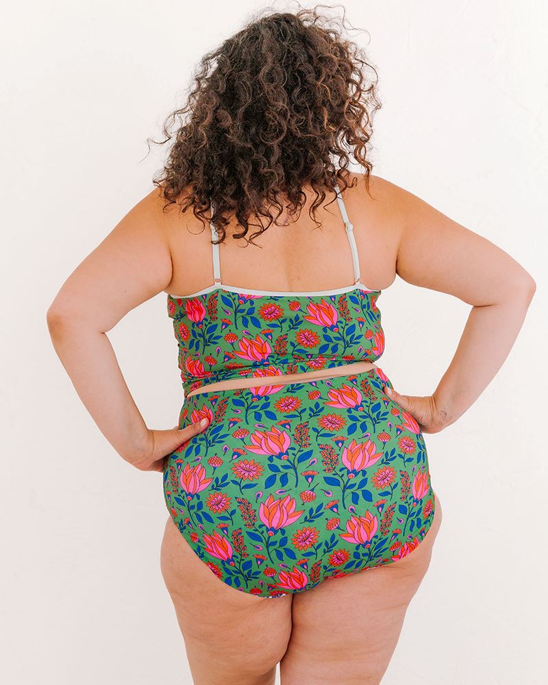 Photo of a woman wearing a Block Floral/ Fresco Floral reversible swim bottom fresco floral side and a Fresco floral swim crop top back angle